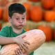 Young boy holds large gourd